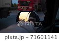 Family trip. The family is driving on the highway. Reflection in the mirror. Sunset time 71601141