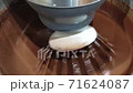 Abstract of chocolate cake batter being mixed in an electric mixer. Extreme shallow DOF with focus on wire mixer	 71624087