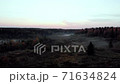 Aerial Drone view of the flight over the autumn forest at sunset. There is fog on the ground 71634824