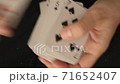 shuffling playing cards, playing cards in hands 71652407