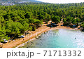 Aerial drone view over the coastline surrounded by green nature and Aegean sea waters in a secret bay in Akbuk, Didim, Turkey 71713332