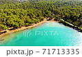 Aerial drone view over the coastline surrounded by green nature and Aegean sea waters in a secret bay in Akbuk, Didim, Turkey 71713335