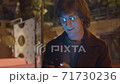 Hipster typing in smartphone 71730236
