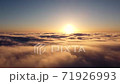 Accelerated recording, a time-lapse flight over the clouds early in the morning when the sun rose on the horizon. 71926993