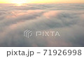 Morning fog and sun on the horizon, time-lapse wind drives clouds high in the sky. 71926998