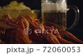 Close up view of lobsters with foamy bear and chips on background in slow motion 72060053