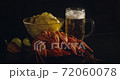 Close up view of lobsters with foamy bear and chips on background in slow motion 72060078