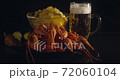 Close up view of lobsters with foamy bear and chips on background in slow motion 72060104