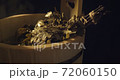 Close up view of oak broom in wooden tub in bath with hot steam from water on black background in slowmotion 72060150