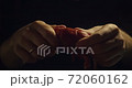 Close up view of hands that burst lobster in black background in slow motion 4k 72060162