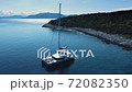 Cutter view from above, stunning aerial view of a boat floating on a beautiful turquoise sea. 72082350