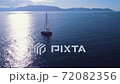 Sailing yachts anchored in a blue calm sea with majestic mountains in the background 72082356