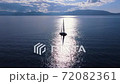 Beautiful white sailboat in open water on sunny weather, aerial view. 72082361
