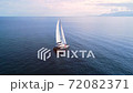 Boating in open sea with beautiful crystal wather and islands on the horizon. 72082371
