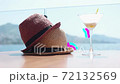 Glow line effect. Two straw hats and martini glasses. 72132569