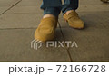 Close up of male legs in sand color boots. 72166728