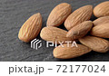 Truck shot almond nuts on black slate board 72177024