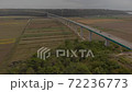 Cars on a concrete bridge over agricultural fields of mirna river valley. Aerial of Istria, Croatia 72236773
