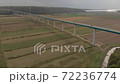 Flying over long Mirna bridge. Cars move on motorway over fields and river. Aerial of Croatia 72236774