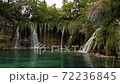 Waterfalls of world-famous Plitvice Lakes. Green picturesque lakeside and transparent water 72236845