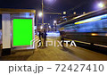 Billboard with a chroma key green screen on n bus stop at night. Time Lapse. 72427410