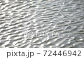 Intense ripple on water surface with sunlight reflection. 72446942