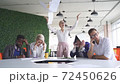 Rude angry female boss executive is dissatisfied irritated by employees, scream at them. 72450626