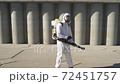 Cleaner with pressurized sprayer in hands going to disinfect public places 72451757