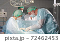 Team of caucasian adult doctors applying first aid, group of doctors and nurses help patient. 72462453