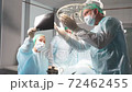 Caucasian surgical team talking about X-ray in an operating theater, discuss x-ray before interfere with body surgery. 72462455