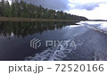 Trail on the water from a motor boat that moves along the lake. 72520166