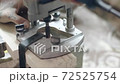 Workshop. Drilling a hole in a wooden board with a power tool 72525754