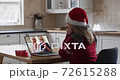Caucasian woman wearing santa hat on laptop video chat during christmas at home 72615288