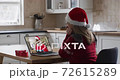 Caucasian woman wearing santa hat on laptop video chat during christmas at home 72615289