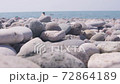 Stones are slowly falling against the background of the sea 72864189