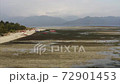 Aerial view of ocean at low tide, motor boats on the ocean floor, green GILI AIR island with white sandy beach. Mountains on the background. Indonesia 72901453