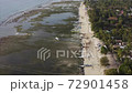 Great aerial view of ocean at low tide, motor boats on the ocean floor, green GILI AIR island with white sandy beach. Indonesia 72901458