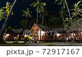 Zooming out timelapse of picturesque woonden indonesian houses with straw roofs and palms under wonderful sky with million bright stars. GILI AIR Air island 72917167