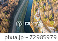 Flying above the water channel in the forest. Drone aerial footage 72985979
