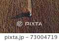 Aerial drone view: combine harvester working in a wheat field at sunset. Organic farming. Agriculture theme, harvesting season. 73004719