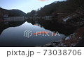 Take a picture of the sunrise on a small dam lake in the mountains-reflecting clouds flowing on the mirror-like surface of the water Take a picture of the sunrise on a small dam lake in the mountains-reflecting clouds flowing on the mirror-like surface of the water 73038706