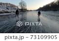Two people skating ice river 73109905