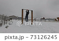 Man working out outdoors during winter 73126245