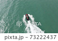 girl driving a scooter in the sea 73222437