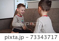Two children, boy brothers, playing rock scissors paper game 73343717