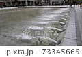 Fountain jet in slow motion in the city fountain 73345665