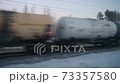 View from the window in winter on an oncoming passing freight train on the railway 73357580