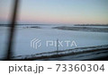 View from the train window on the evening winter landscape 73360304