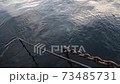 Chains and ropes on the pier going under the water 73485731