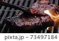 Steak grilled on barbecue fire 73497184